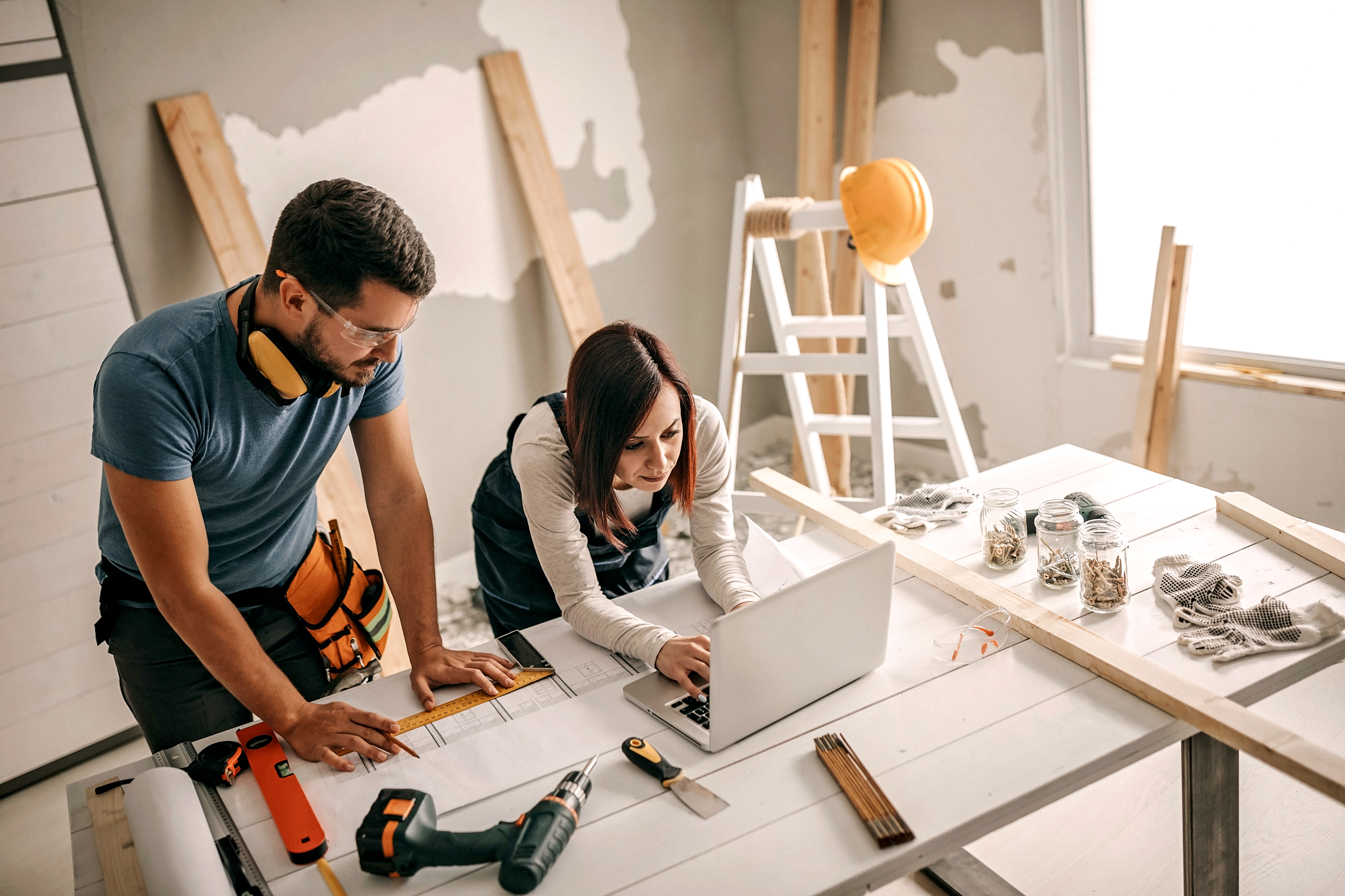 Woman analyzing blueprint for her new home interior