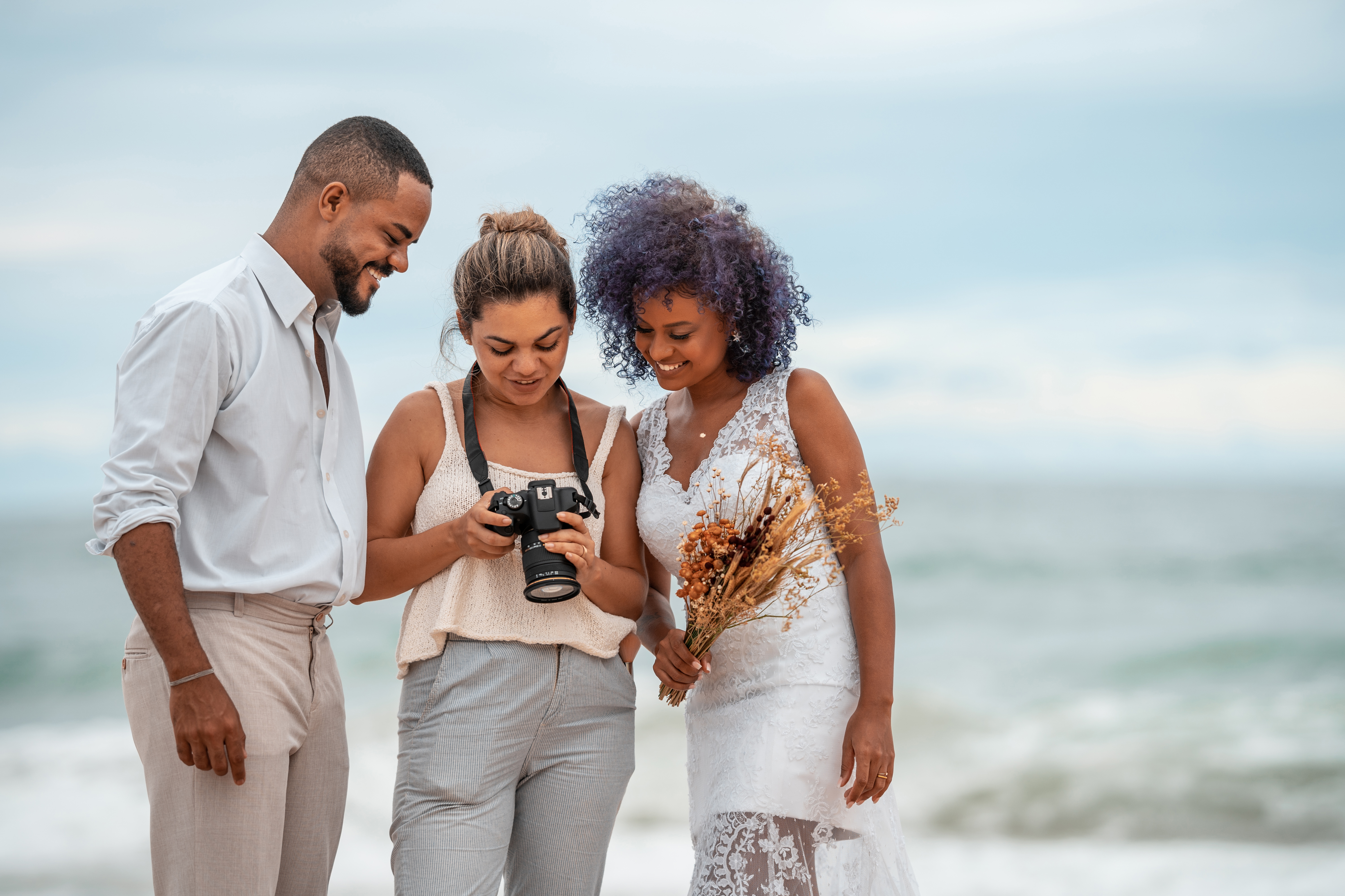 Couple reviewing photos with photographer
