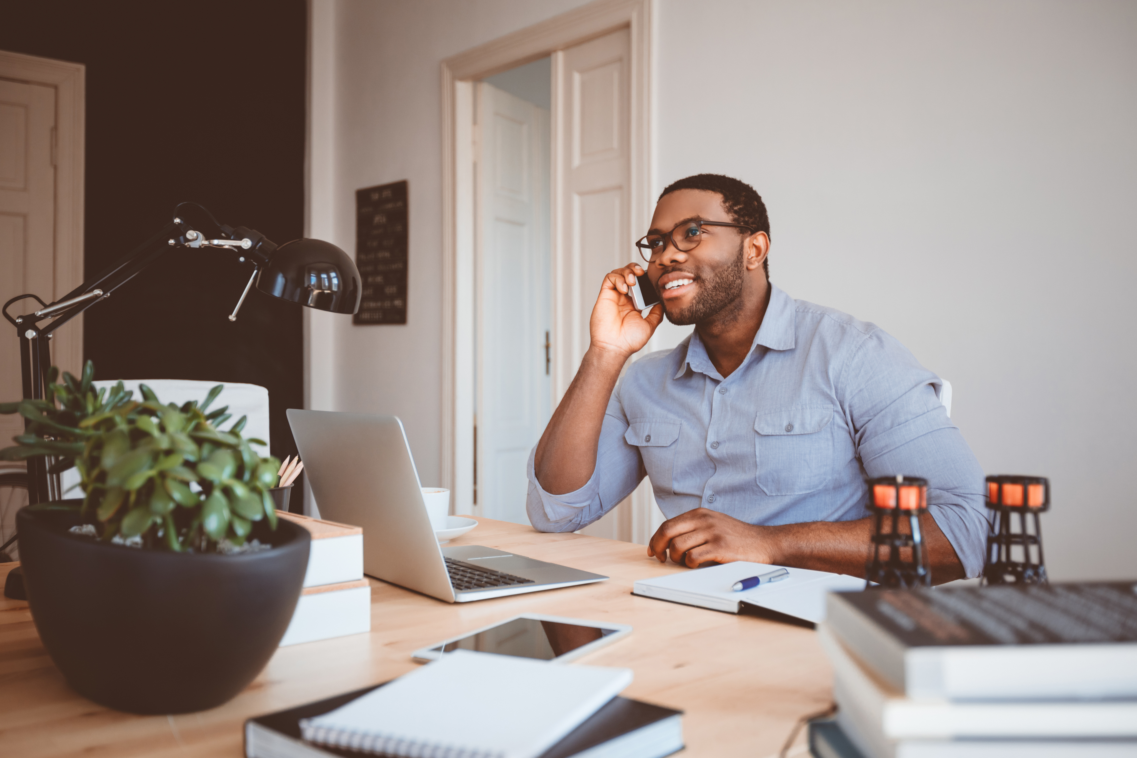 man talking on cell phone while smiling